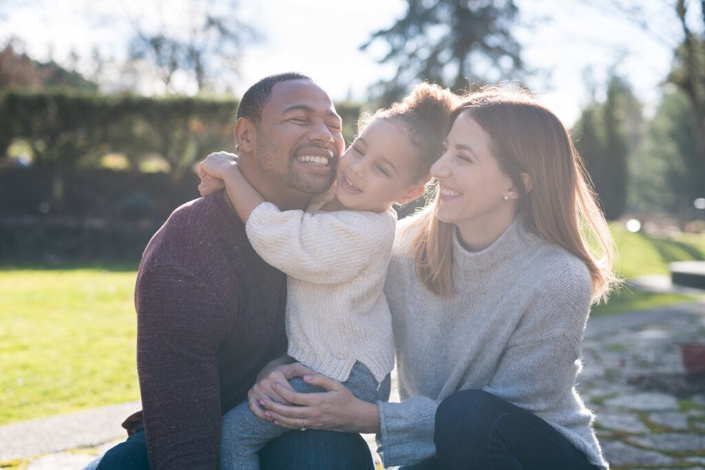 Image of an interracial couple and their daughter enjoying time with each other